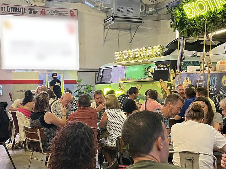 A packed room facing the quiz screen