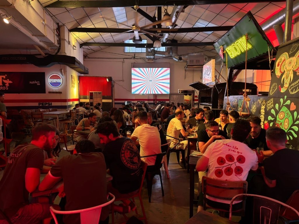 A packed room playing trivia, with the quiz up on the big screen